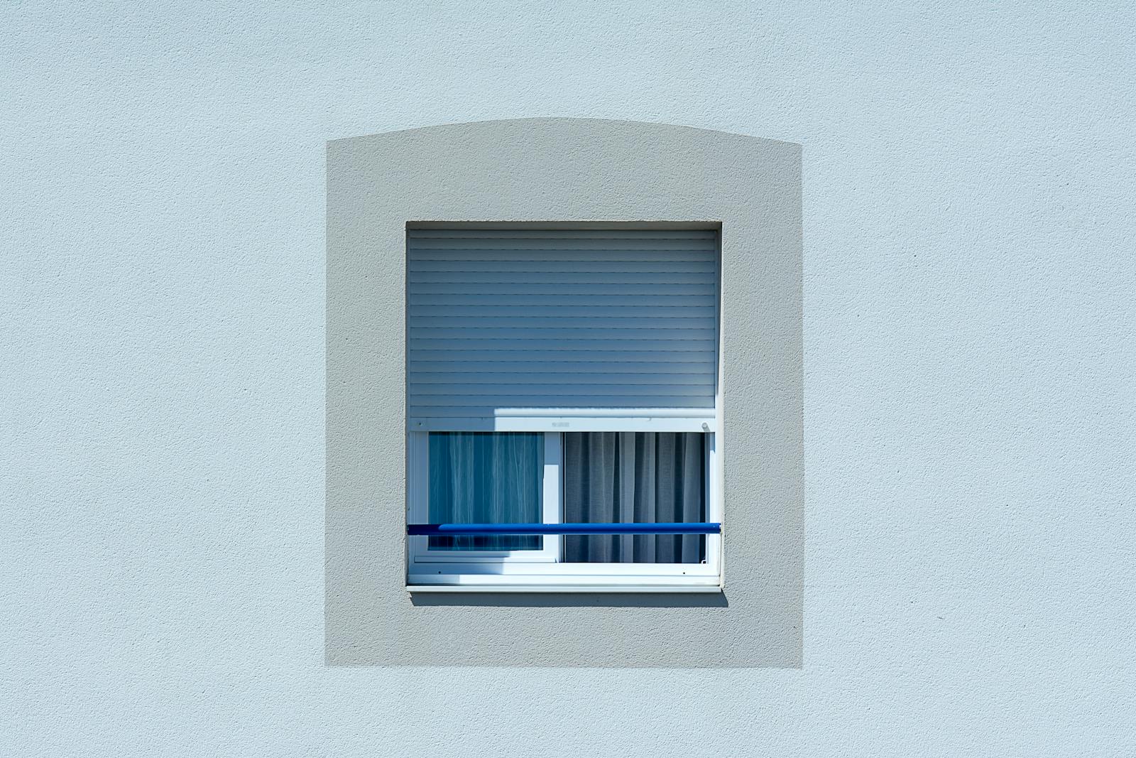 Minimalist room with a clean window treatment